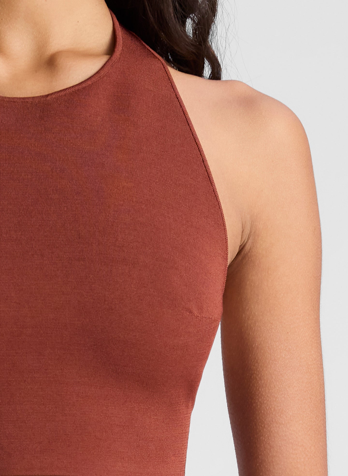 woman wearing maroon knit halter top and maroon midi skirt