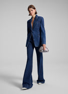 woman wearing medium wash denim suit