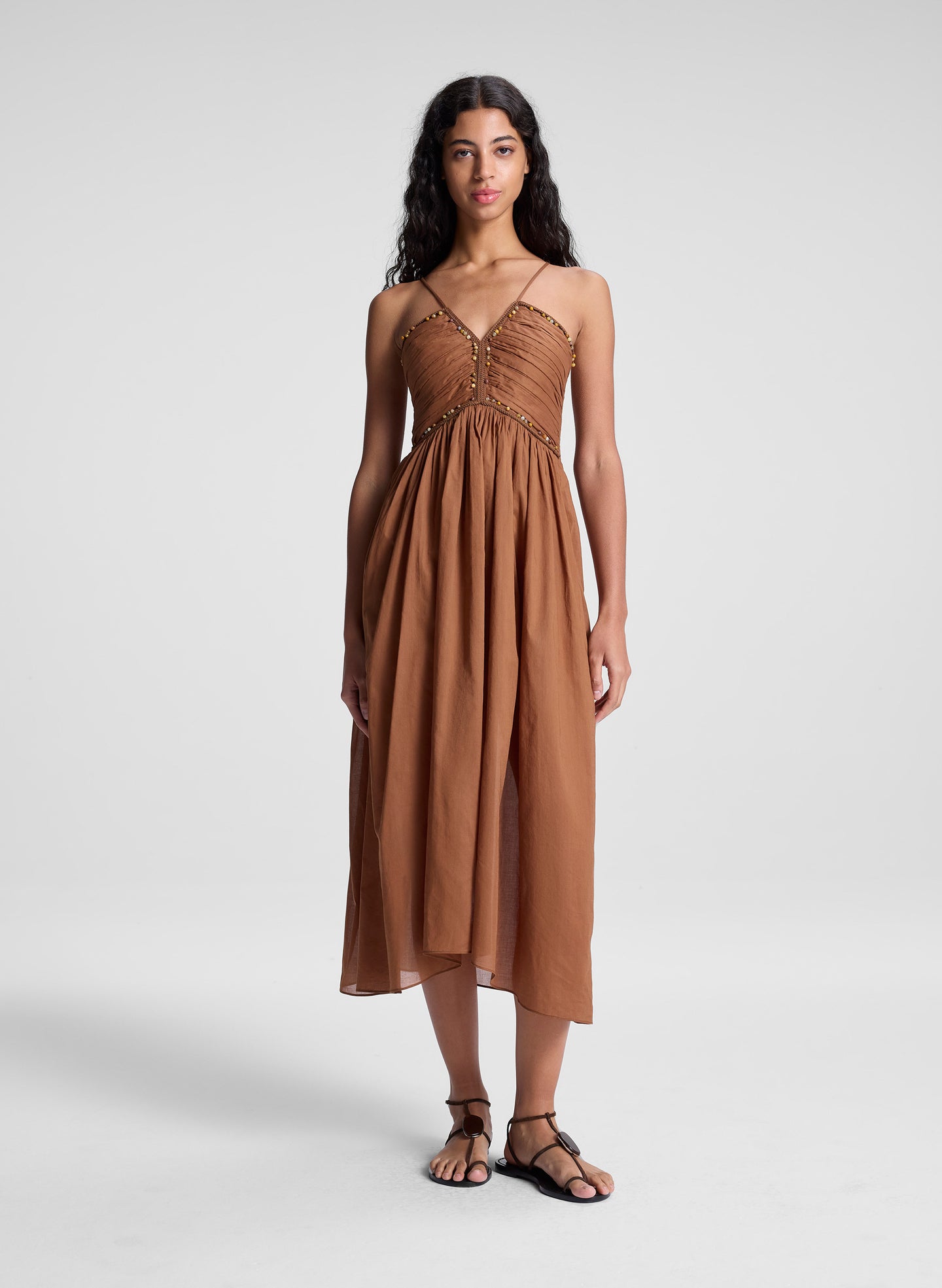 woman wearing light brown midi dress