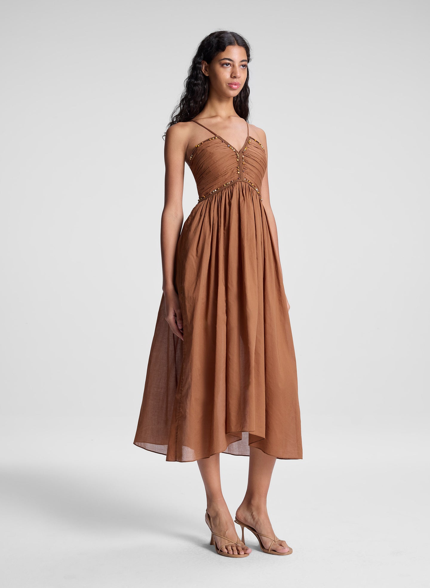 woman wearing light brown midi dress