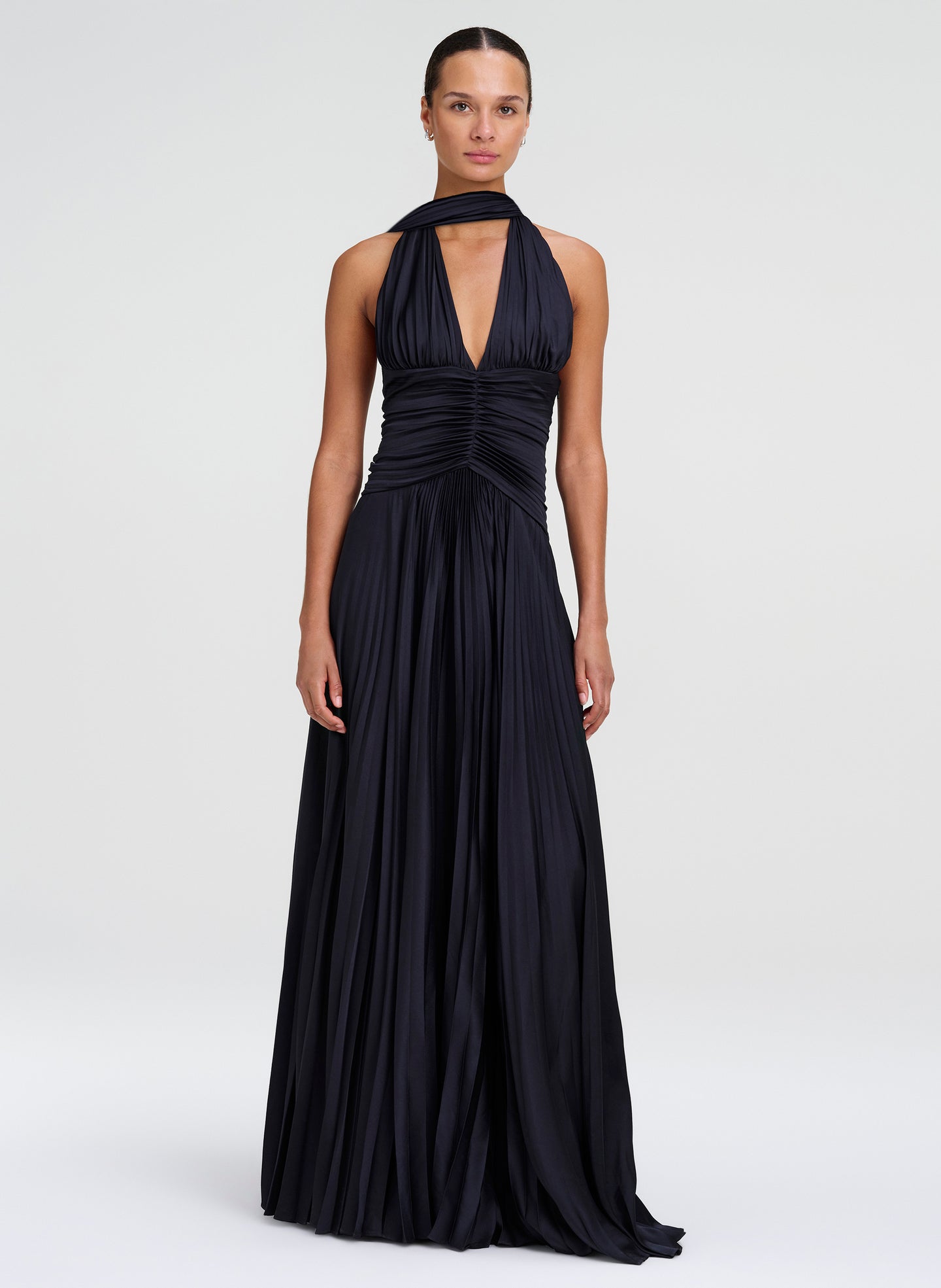woman wearing navy blue pleated gown