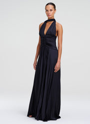 model wearing navy blue satin pleated gown