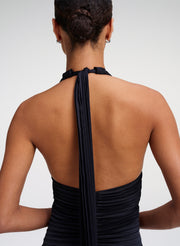 woman wearing navy blue halter back gown