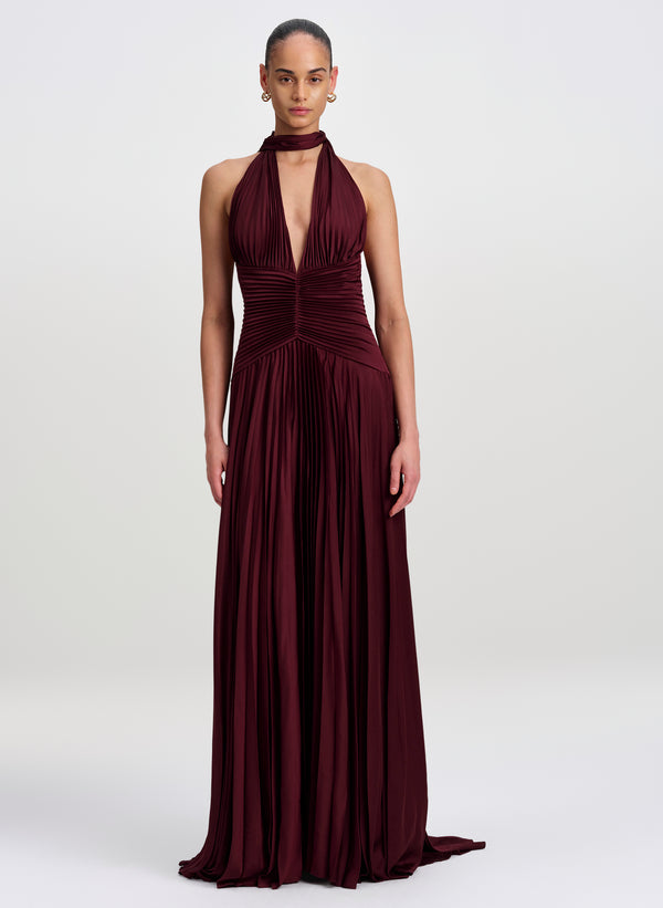 woman wearing burgundy pleated gown with scarf detail
