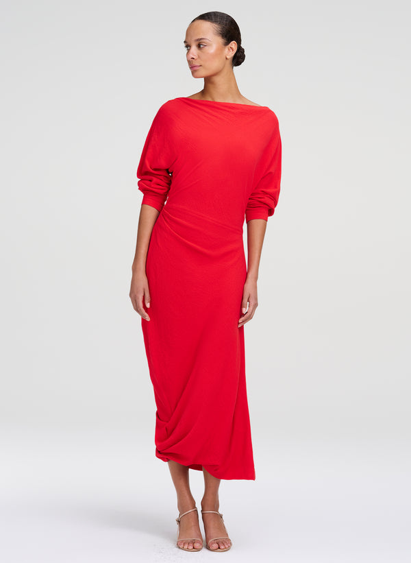 woman wearing red boatneck dress with ruched sleeves