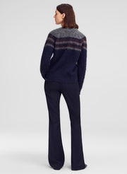woman wearing alpaca striped sweater and blue pants