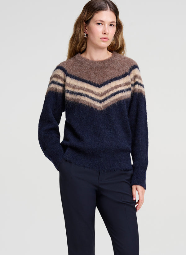 woman wearing brown and navy blue sweater with navy blue pants