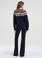 woman wearing brown and navy sweater with navy pants