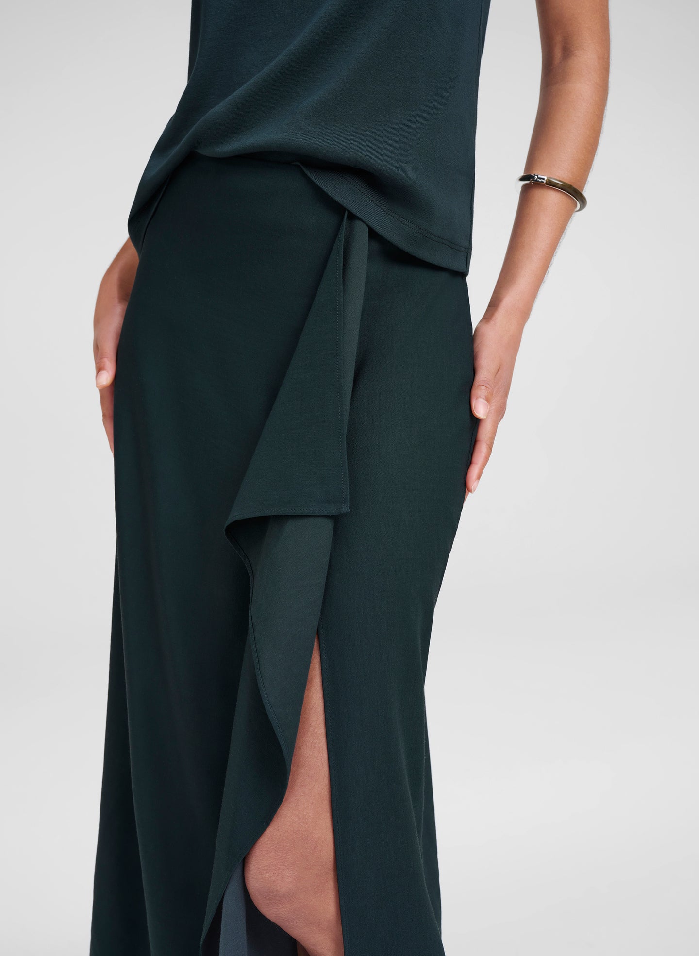Dark green skirt with a draped design on a white background