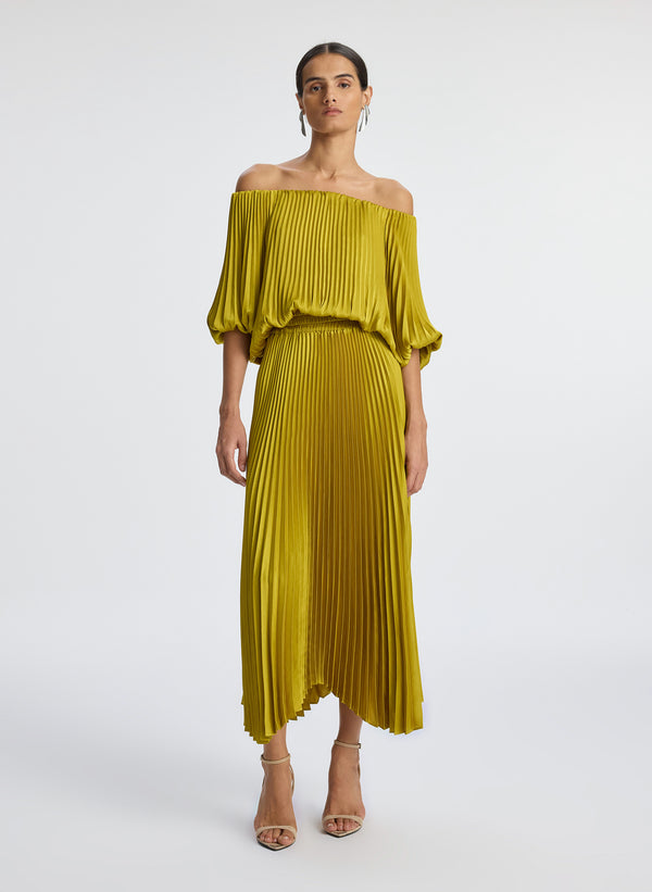 front view of woman wearing yellow pleated off shoulder dress