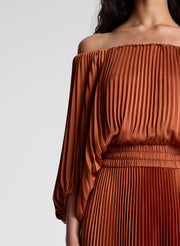 woman wearing orange off shoulder pleated midi dress