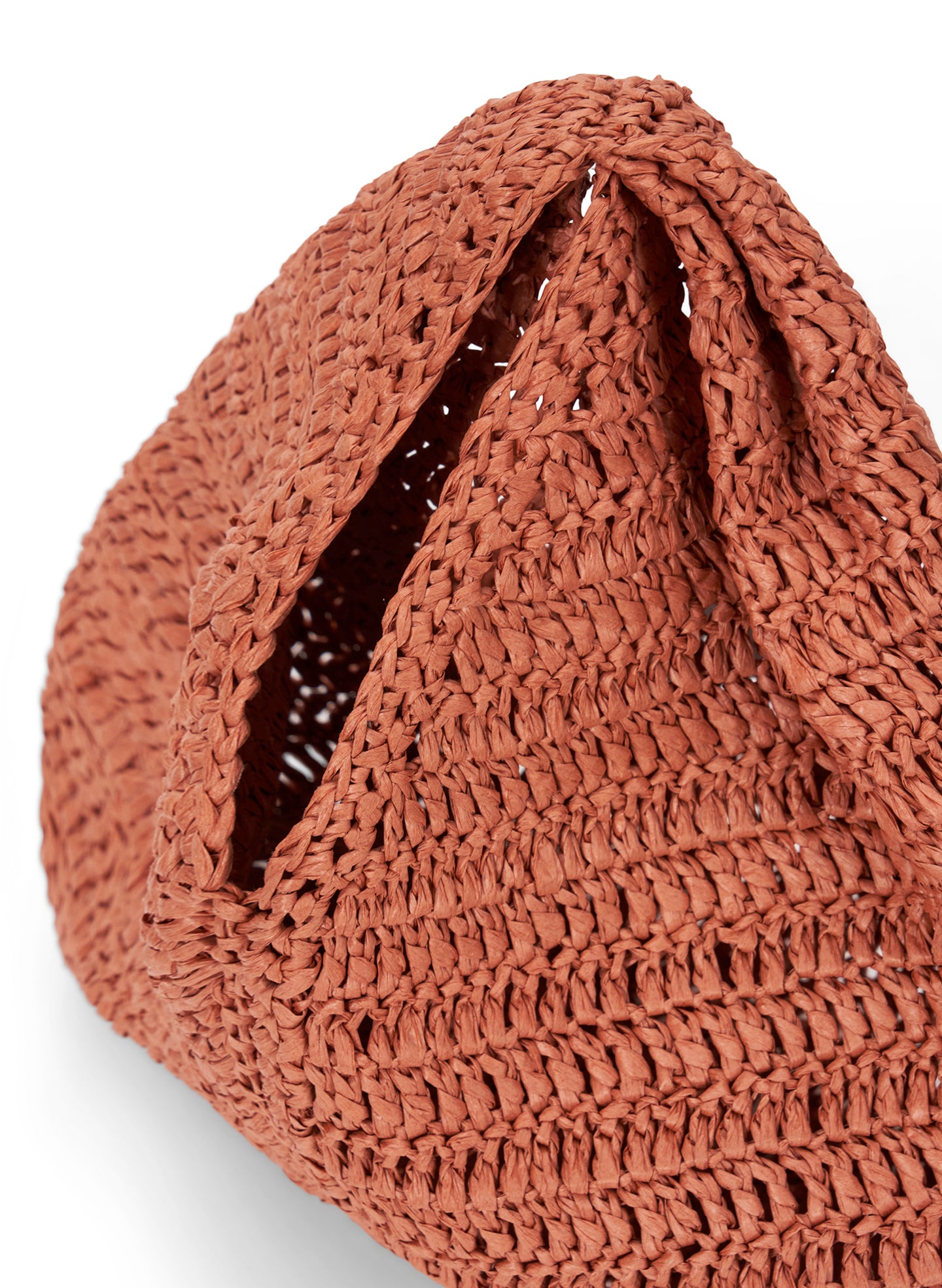 detail view of small raffia woven handbag in brown