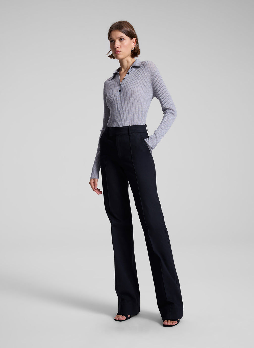 woman wearing navy blue pants and grey knit top