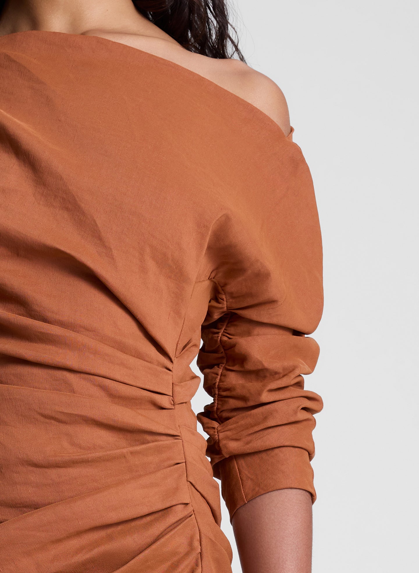 woman wearing orange off shoulder mini dress