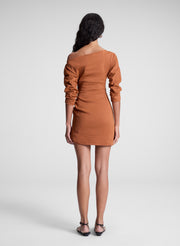 woman wearing orange off shoulder mini dress