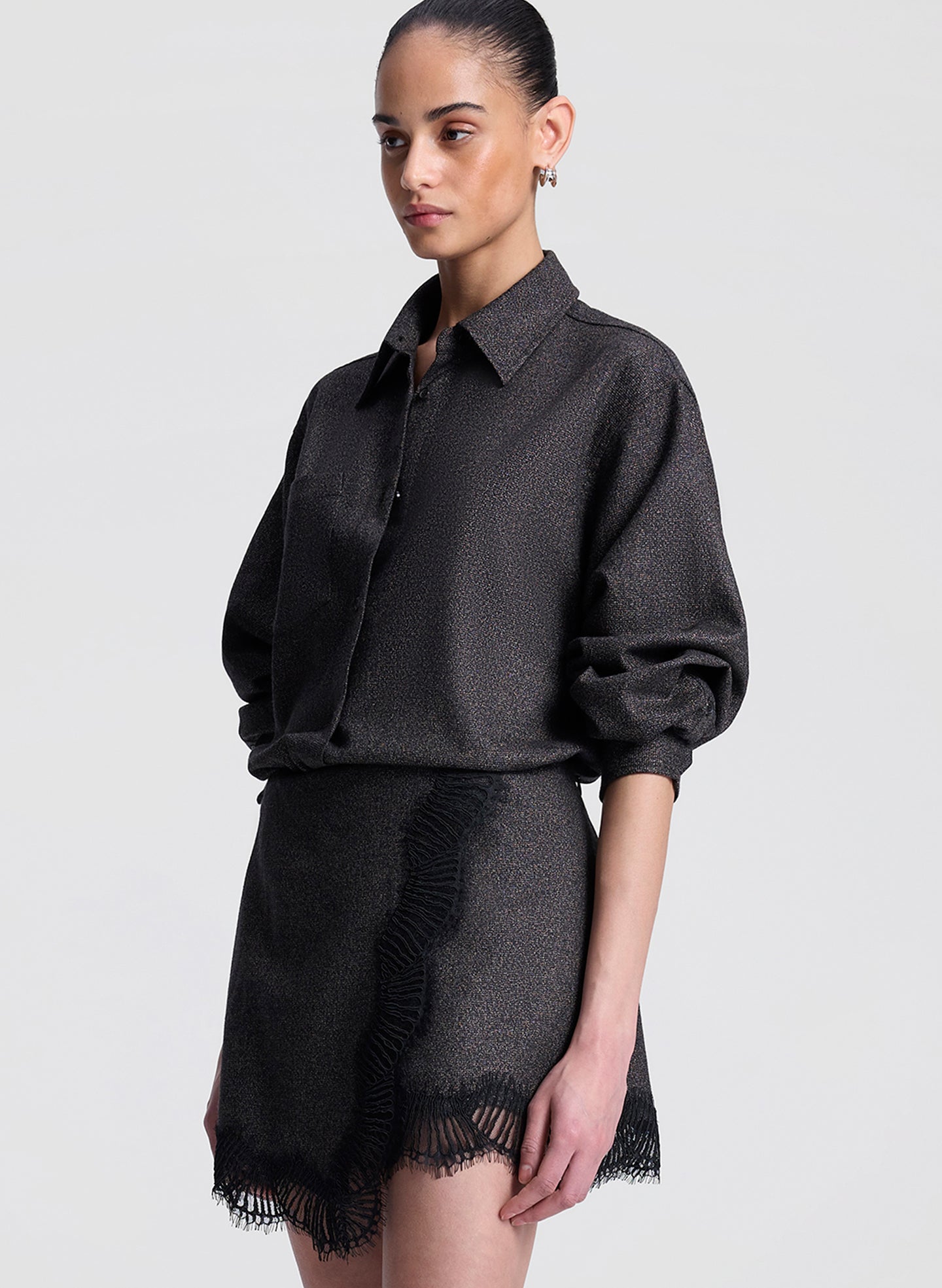 woman wearing brown and black shirt with matching lace trimmed mini skirt