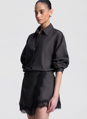 woman wearing brown and black shirt with matching lace trimmed mini skirt