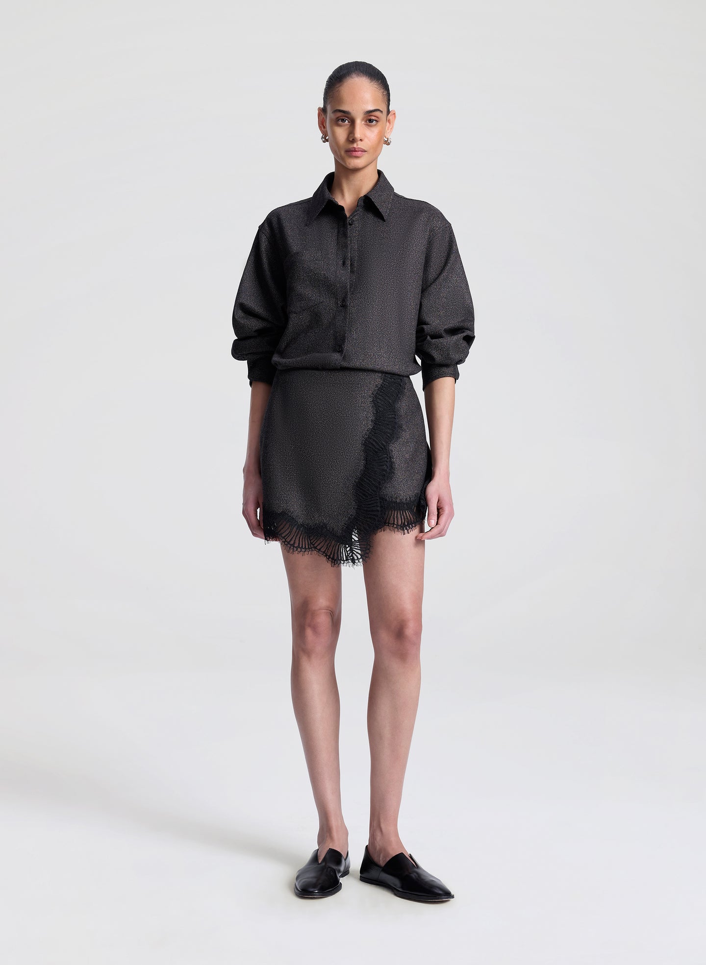 woman wearing brown and black shirt with matching lace trimmed mini skirt