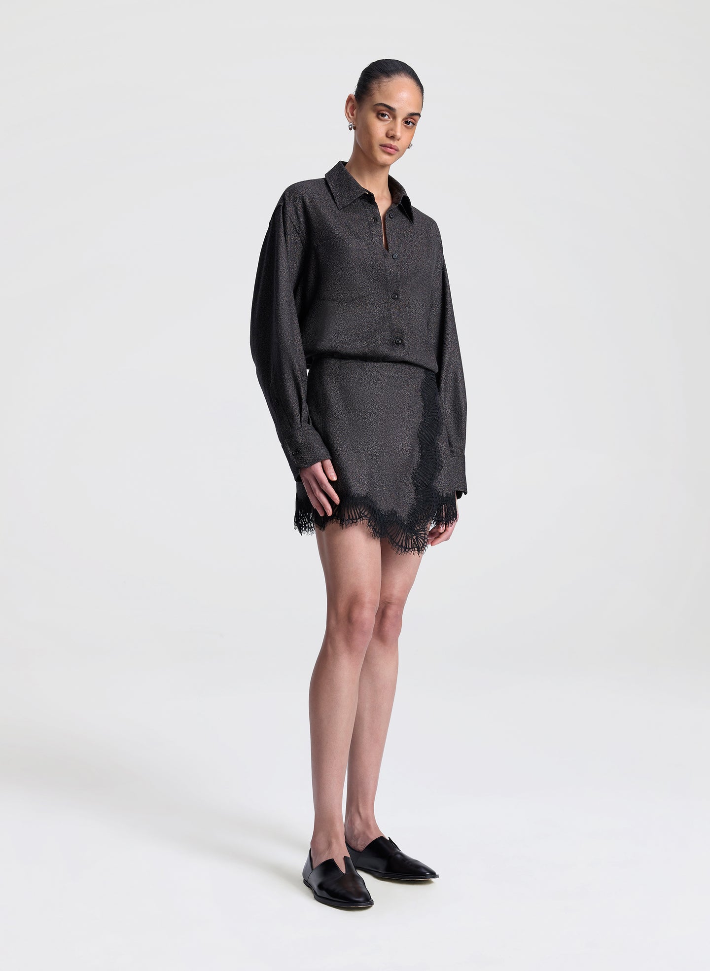 woman wearing brown and black shirt with matching lace trimmed mini skirt