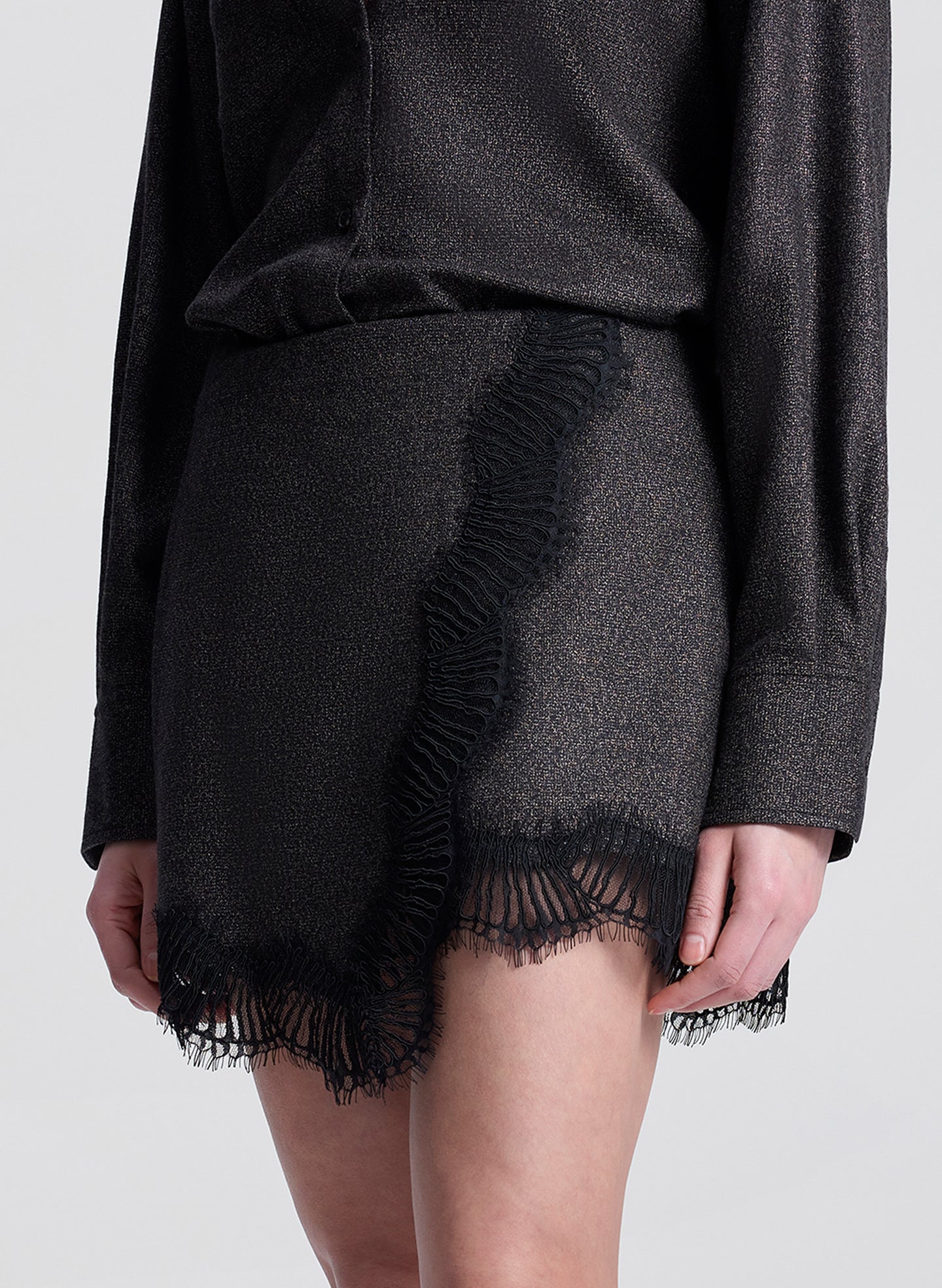 woman wearing brown and black shirt with matching lace trimmed mini skirt