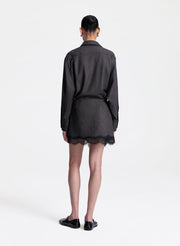 woman wearing brown and black shirt with matching lace trimmed mini skirt