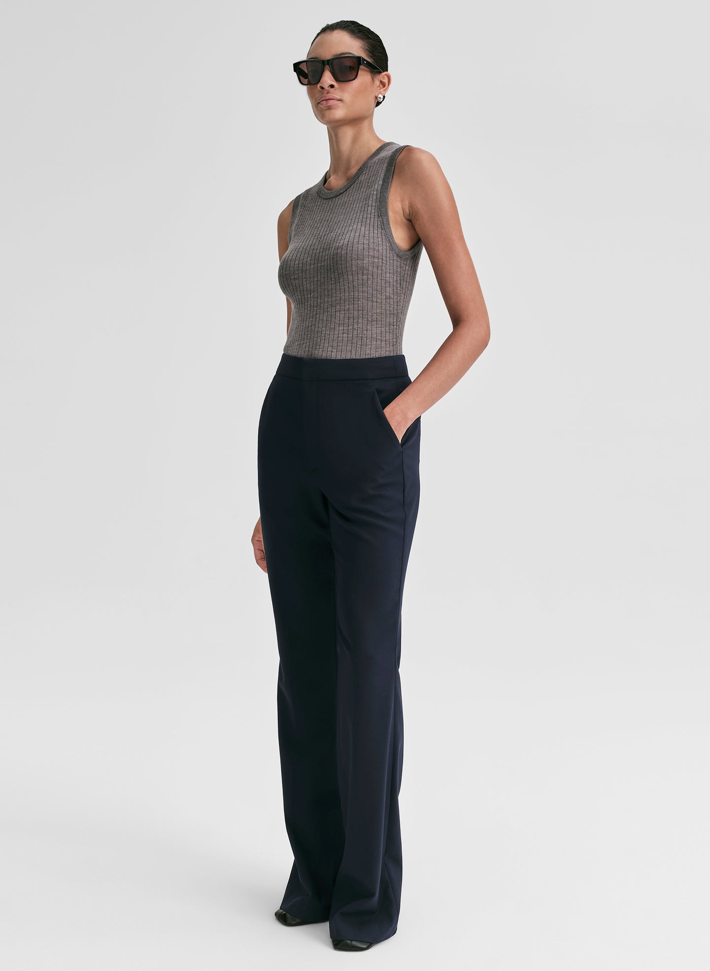 woman wearing grey merino tank and navy blue pants
