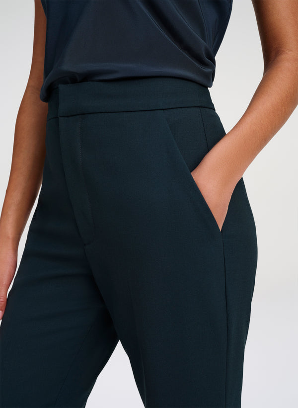 woman wearing green tailored pants