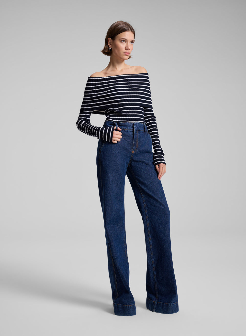 woman wearing striped off shoulder top and denim jeans