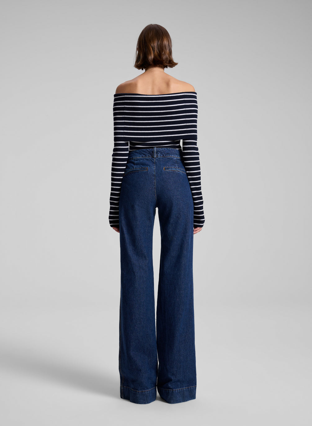 woman wearing striped off shoulder top and denim jeans