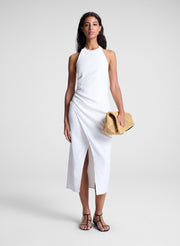 woman wearing white midi halter dress