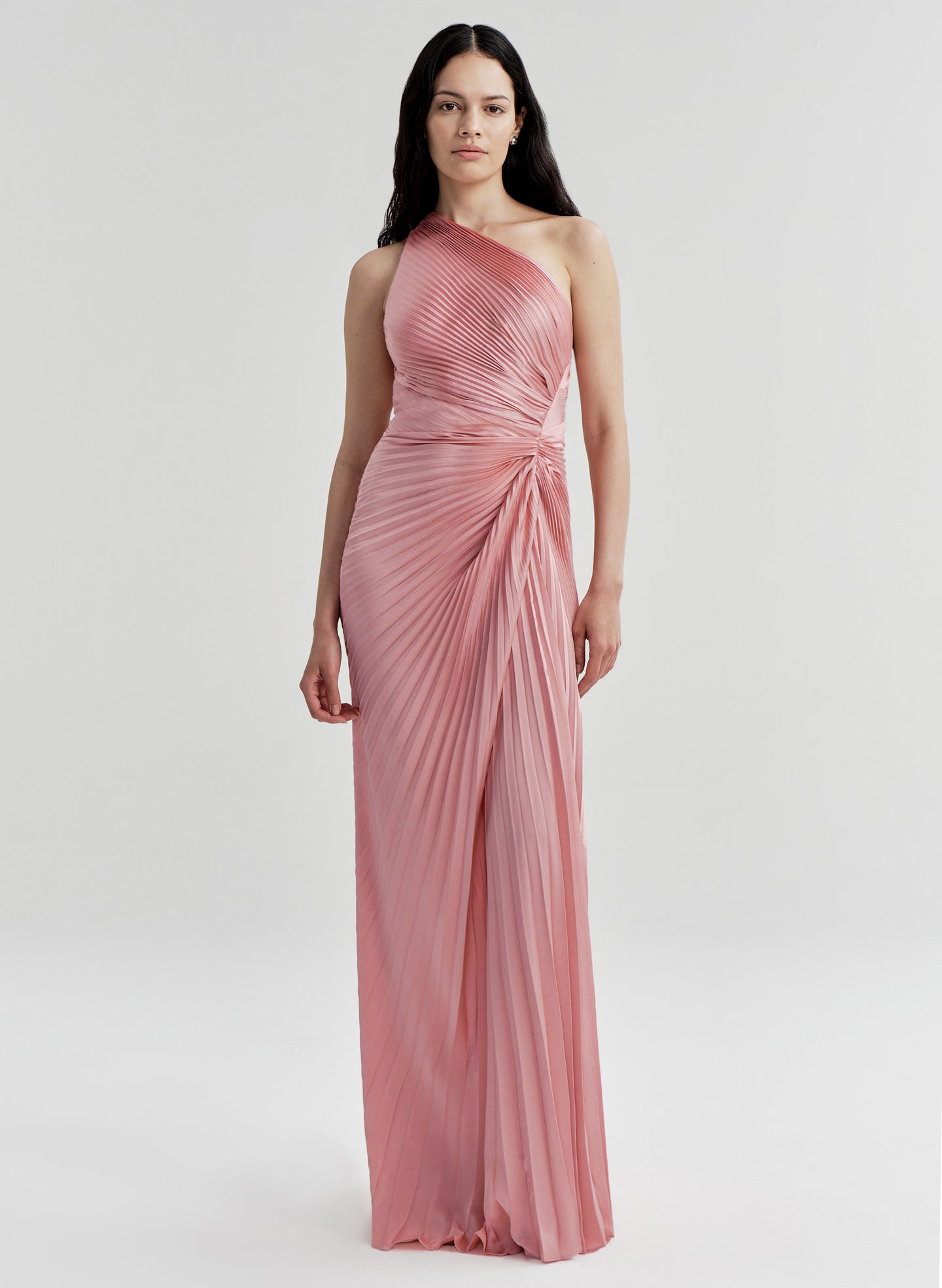 Woman wearing a pink one-shoulder gown on a white background