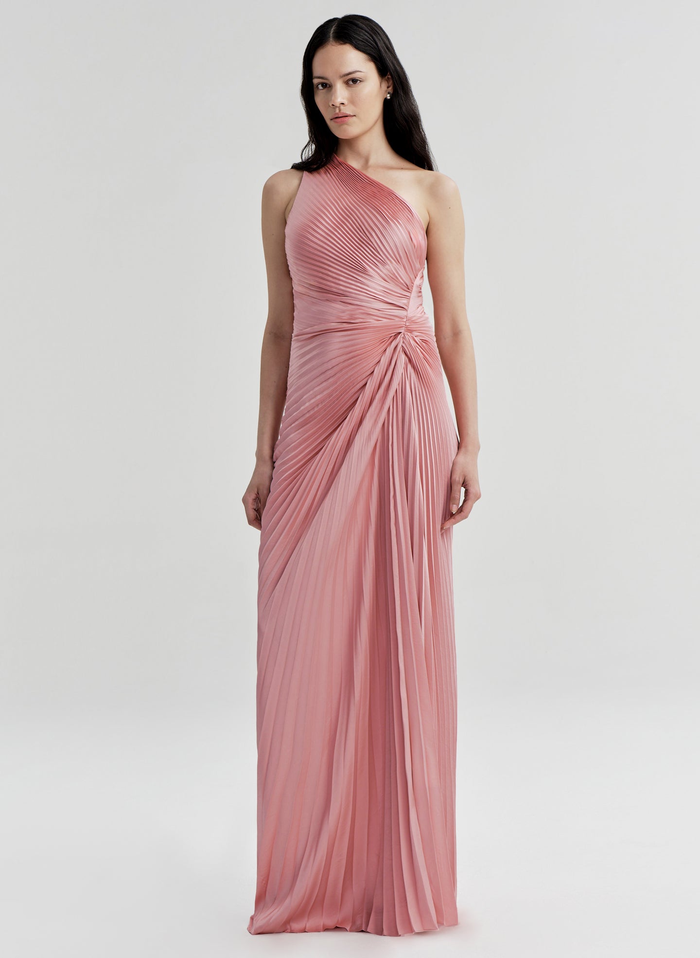 Woman wearing a pink one-shoulder gown on a white background