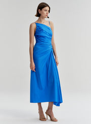 Woman wearing a blue midi dress on a light gray background