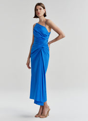 Woman wearing a blue midi dress on a light gray background