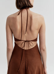 Brown dress with open back on a white background