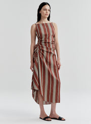 Woman wearing a linen brown and beige striped dress on a white background