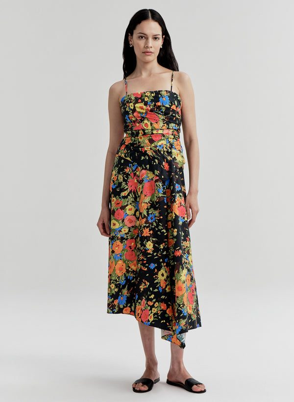 Woman wearing a colorful floral dress on a white background