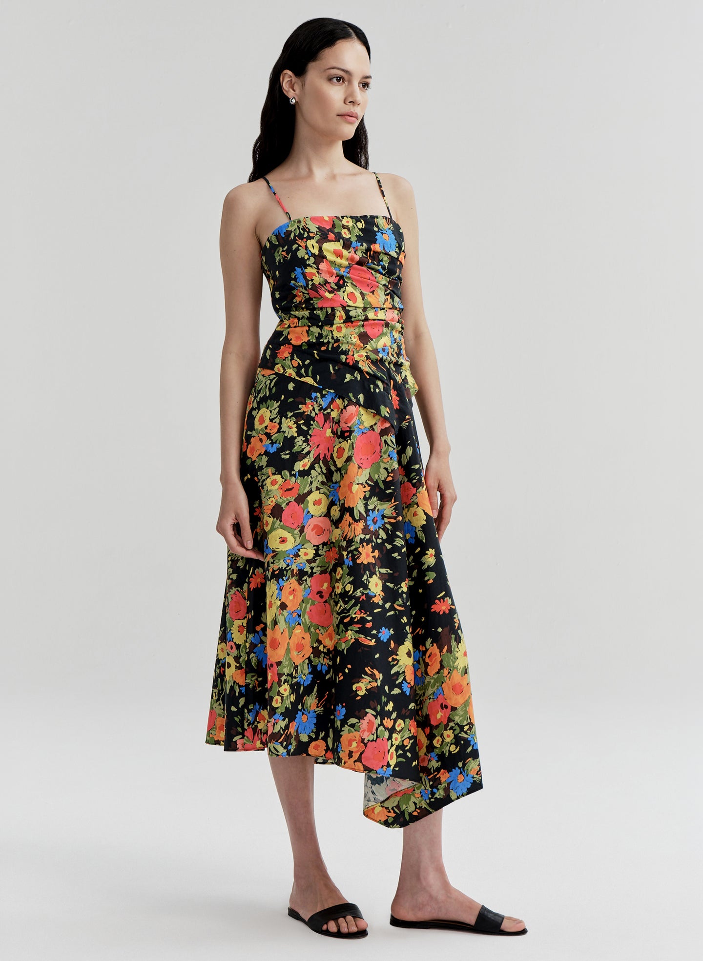 Woman wearing a colorful floral dress on a white background