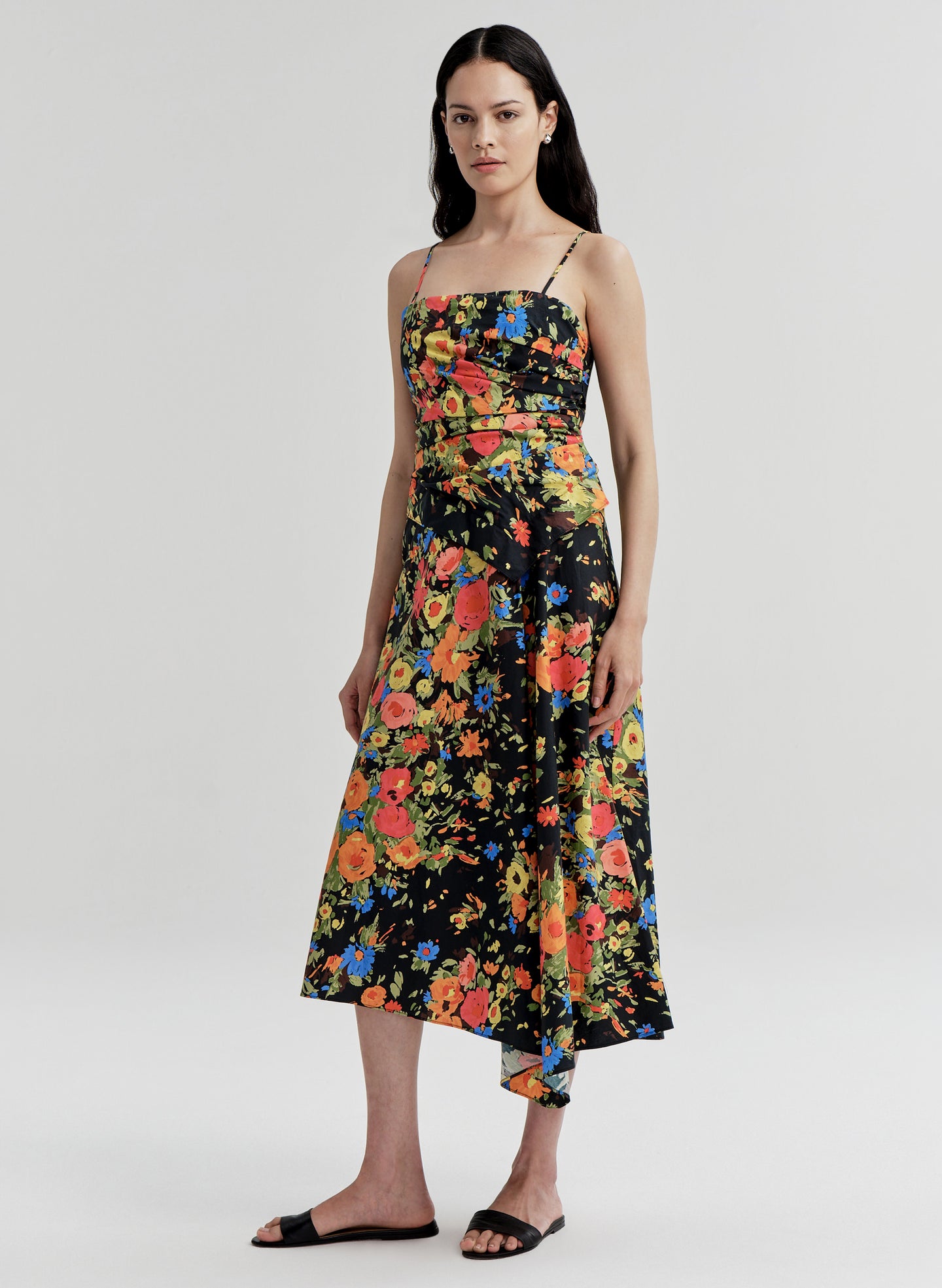 Woman wearing a colorful floral dress on a white background