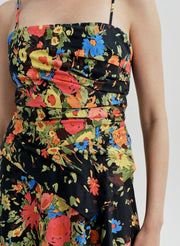 Woman wearing a colorful floral dress on a white background