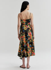 Woman wearing a colorful floral dress on a white background