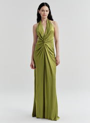 Woman wearing a green halter neck gown on a white background