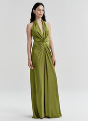 Woman wearing a green halter neck gown on a white background