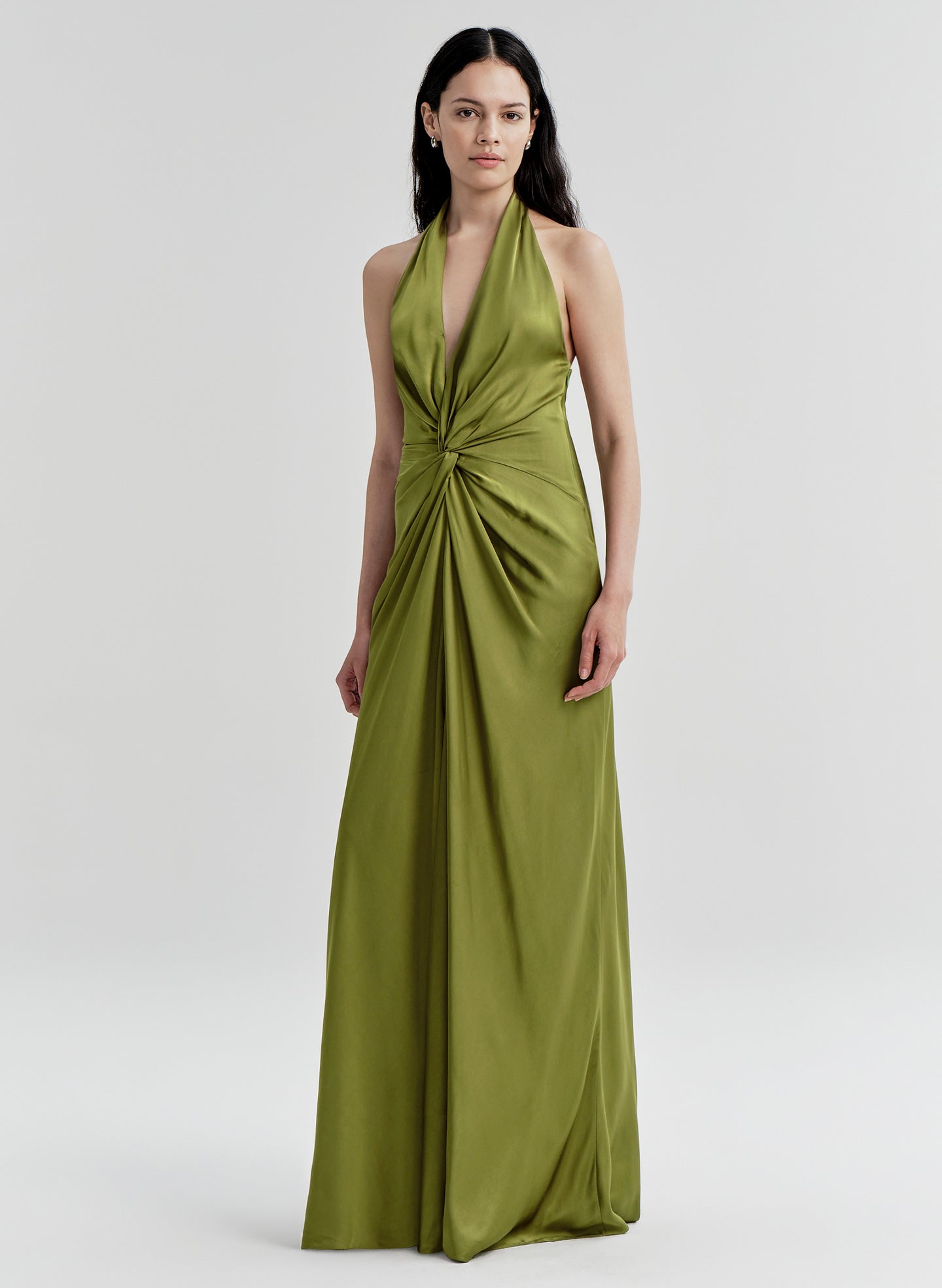 Woman wearing a green gown on a white background