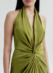 Green halter neck gown with a knot detail on a white background