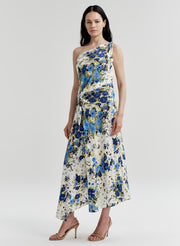 Woman wearing a floral one-shoulder dress on a white background