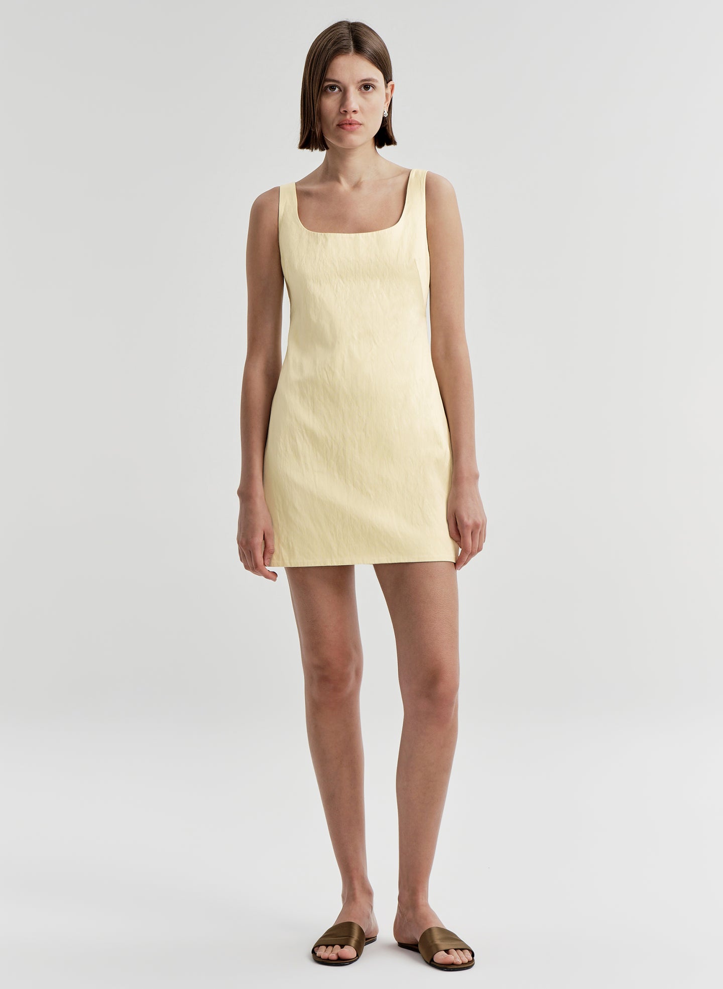 woman wearing yellow satin mini dress