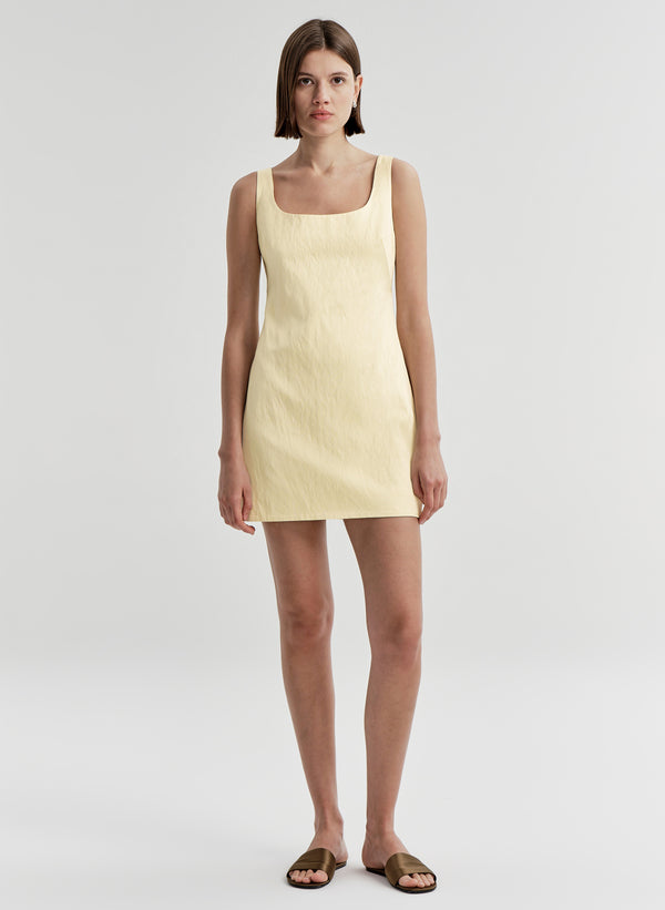 woman wearing yellow satin mini dress