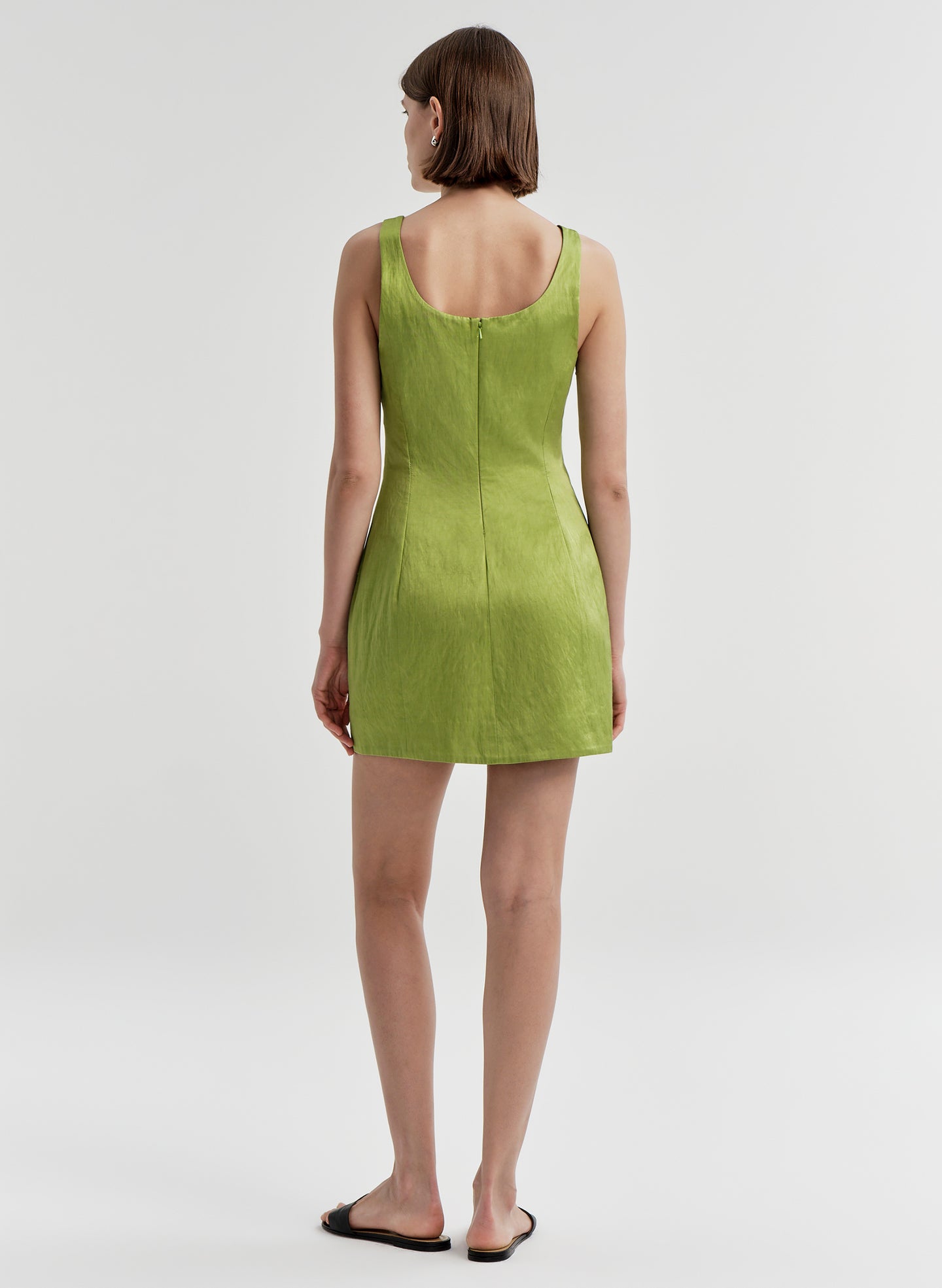 Woman wearing a green dress on a white background