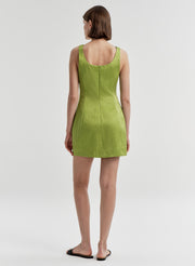 Woman wearing a green dress on a white background